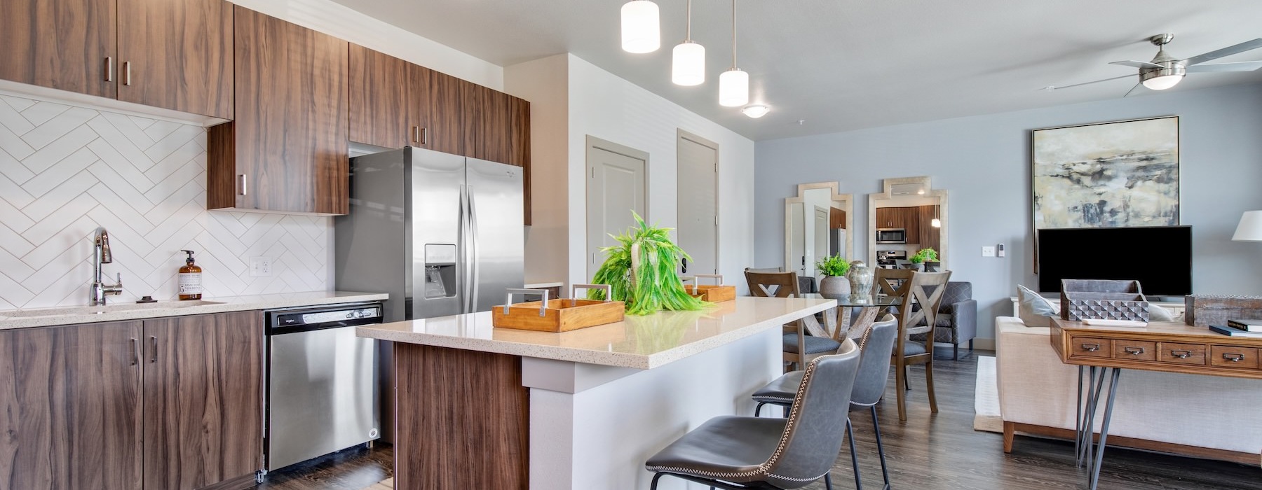a kitchen with a bar and chairs