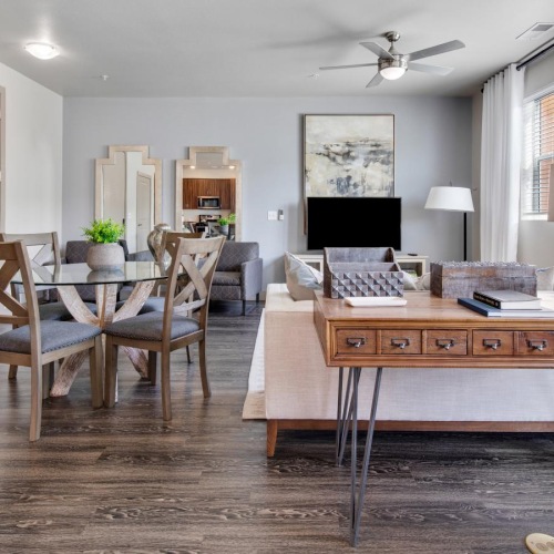 a living room with tables, chairs and a tv