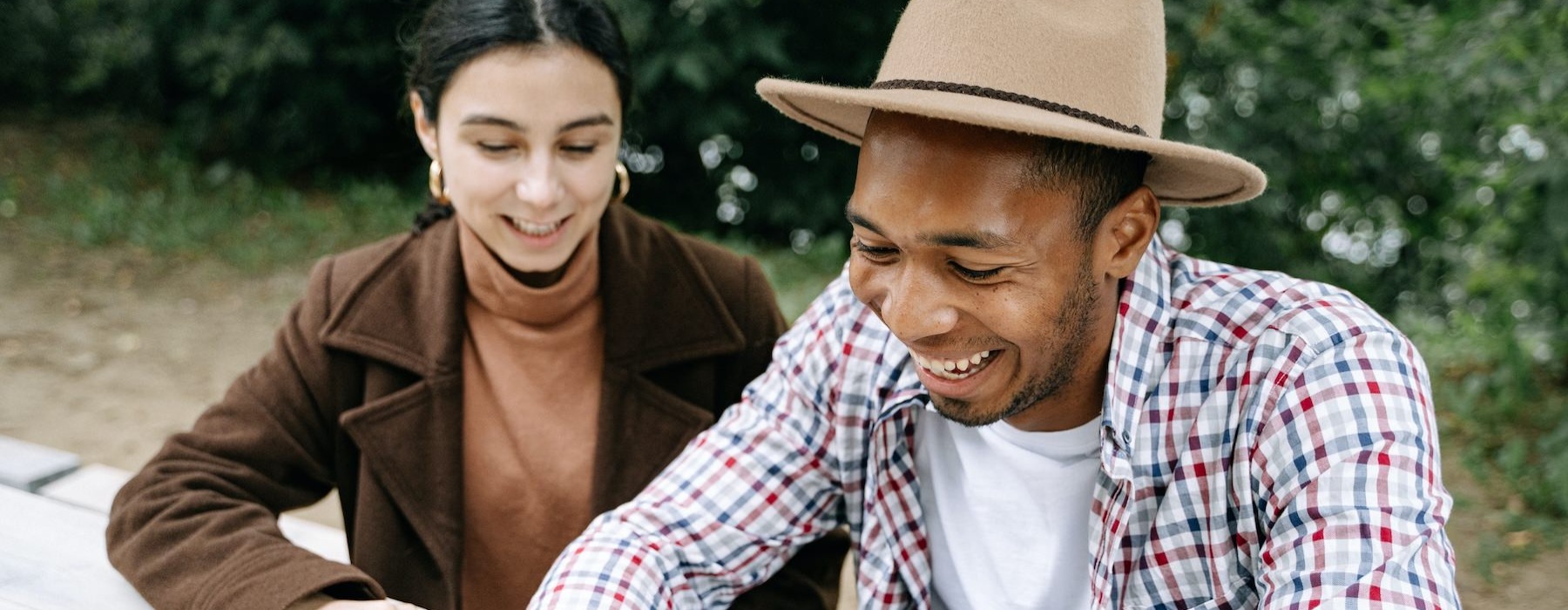 a man and a woman looking at a phone
