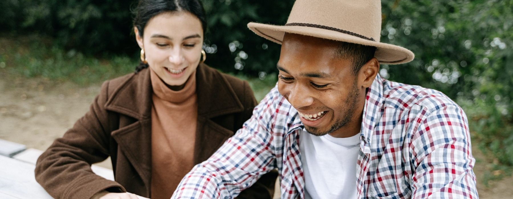 a man and a woman looking at a phone