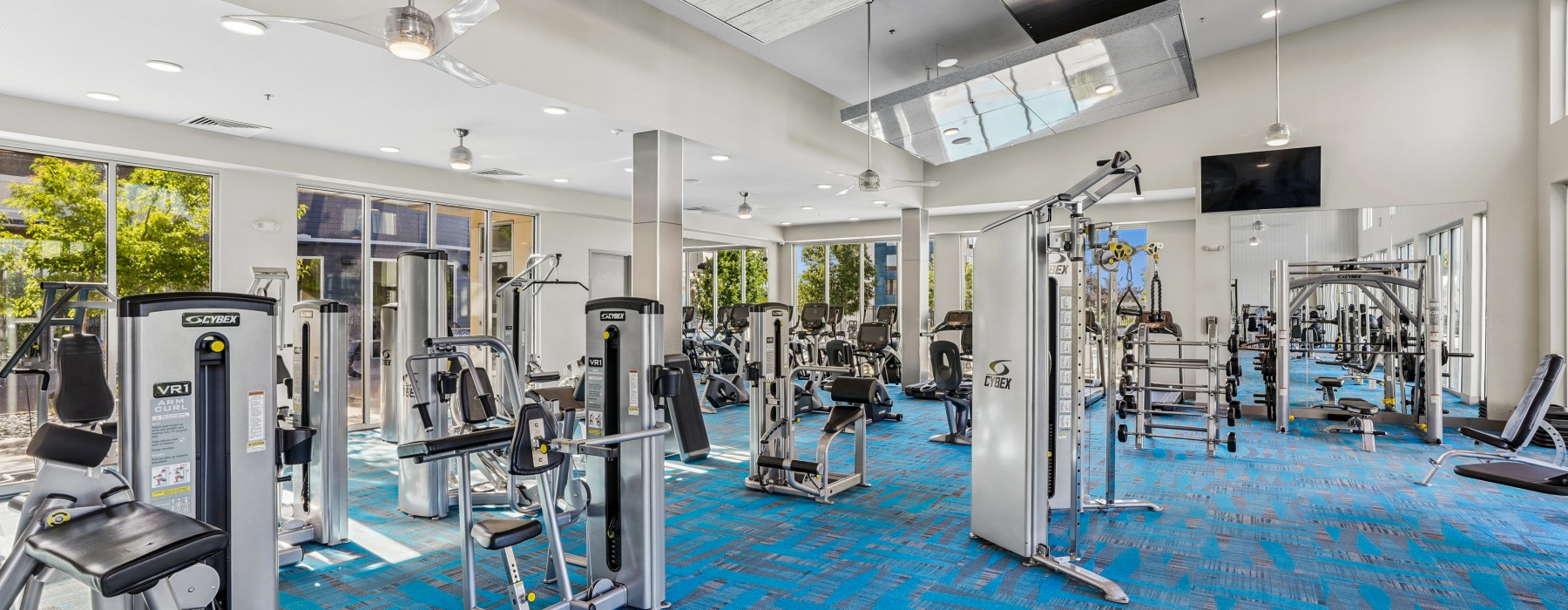 24-hour fitness with cable machines and weightlifting.