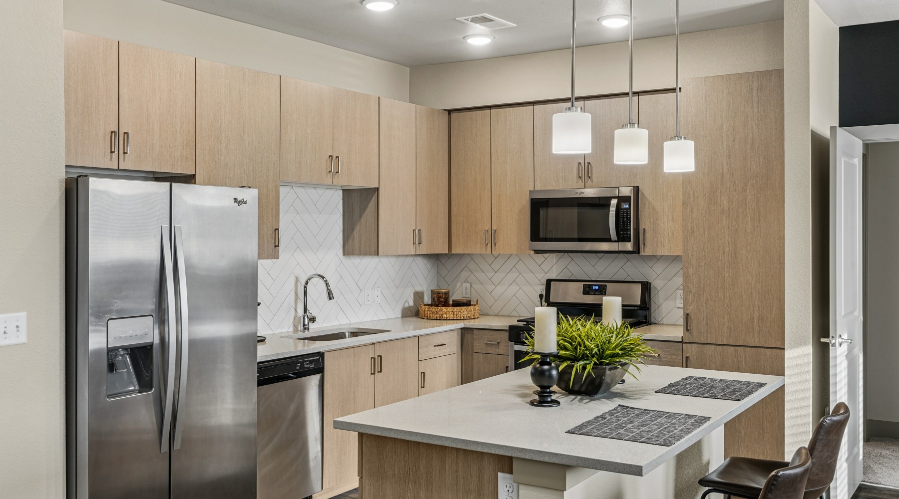 Modern kitchens with stainless steel appliances and pendant lighting